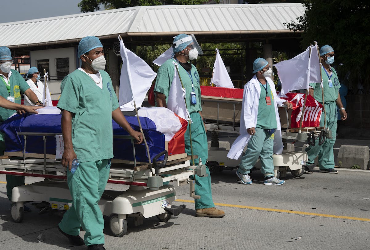 Doctors walking with coffin on a trolly