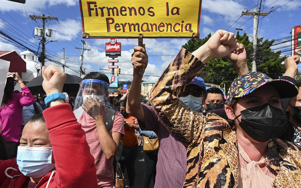 People holding banners and protesting in Honduras