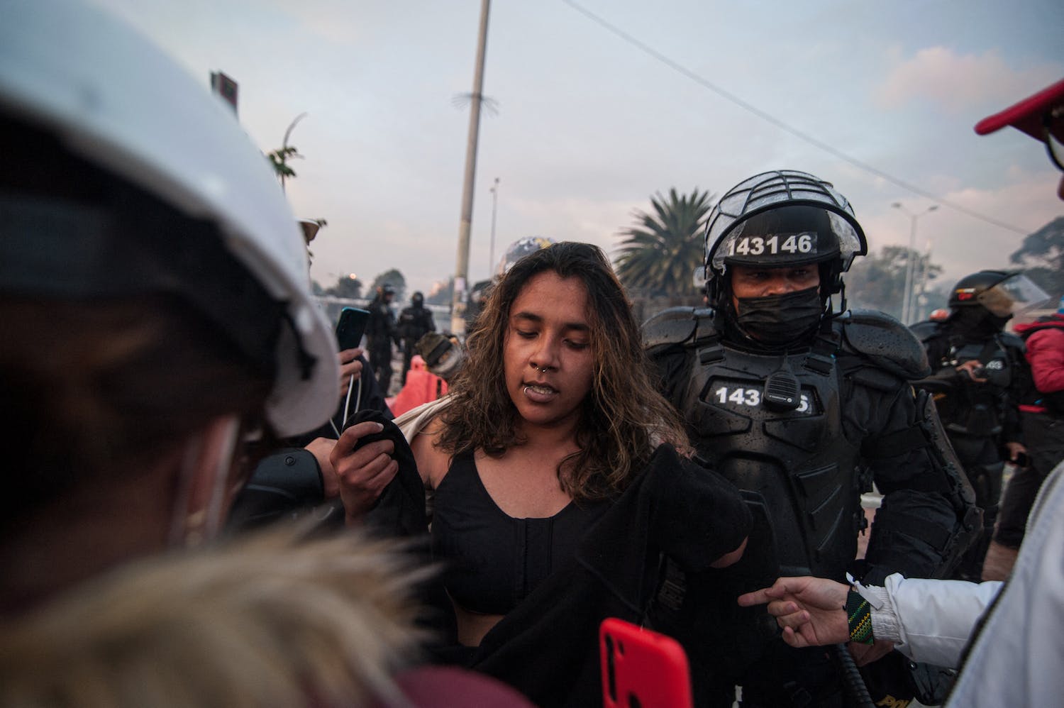 Lady at a protest being taken away by police